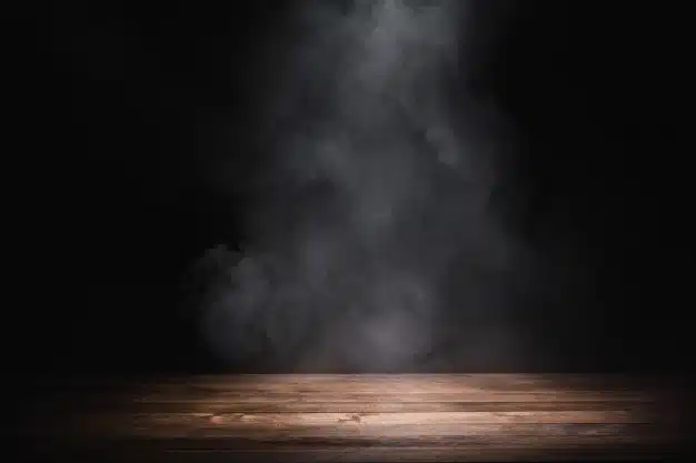 Empty wooden table with smoke float up on dark background Premium Photo