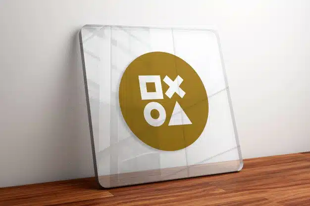 Gold logo mockup on glass on wooden table Premium Psd