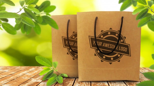 Realistic mockup of two disposable paper shopping bags on rustic wooden table Premium Psd