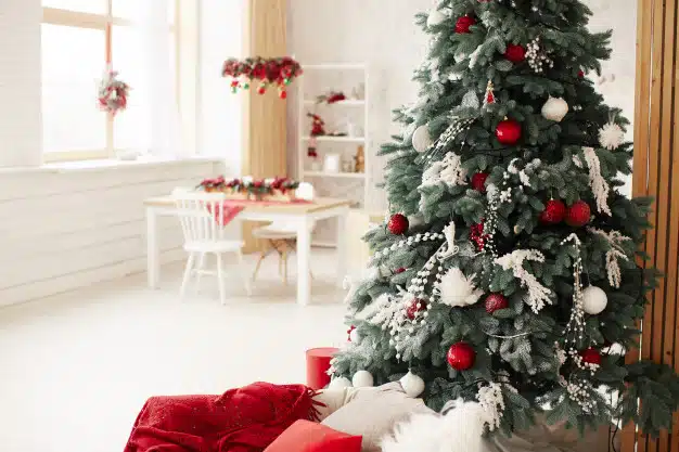 Winter holidays decor. rich decorated new year tree stands with present boxes Free Photo