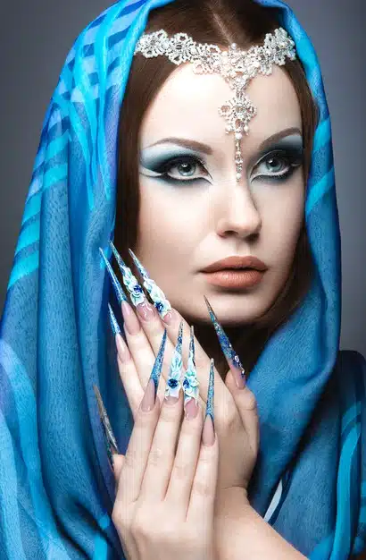 Beautiful girl in eastern arabic image with long nails and bright blue make-