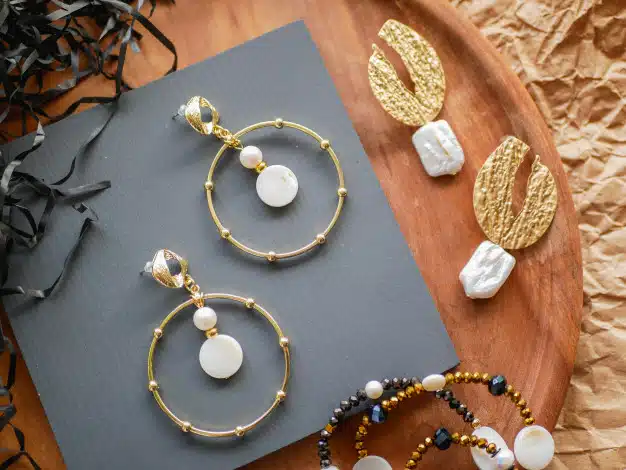Gold earrings. women's jewelry. vintage decoration background. beautiful golden tones