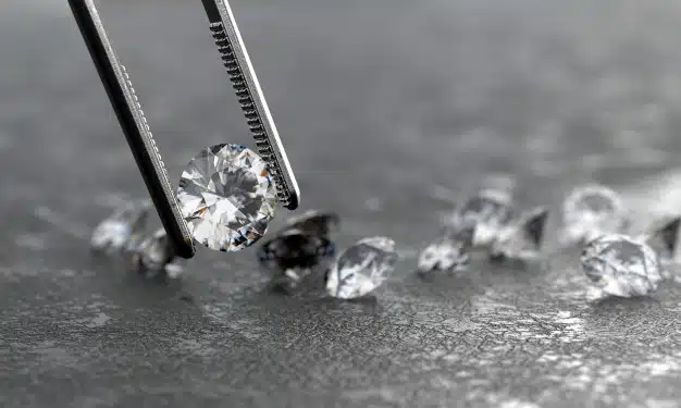 Realistic diamond in tweezers soft focusing Premium Photo