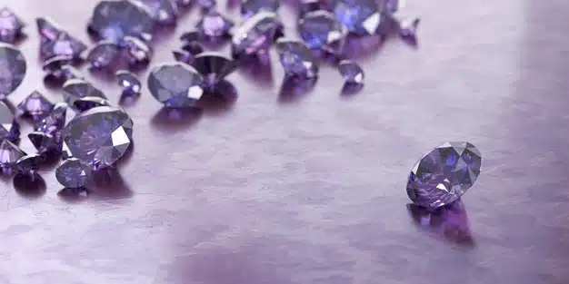 Round purple gems and jewelry diamond groups placed on glossy background Premium Photo